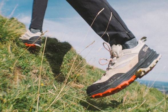 Summery shot of two hikers with hiking rucksacks in a sporty look from behind